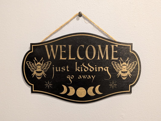 Funny Welcome Sign - “Welcome Just Kidding Go Away” - Laser Engraved Wooden Door Sign with Bees & Moon Phases, Gothic Cottagecore Home Decor
